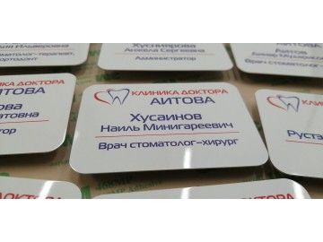 Один бейдж «Клиника Доктора Аитова, Хусаинов Наиль Минигареевич, врач стоматолог-хирург» крупно — бейджи Уфа — типография НеоШтамп